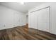 Bedroom featuring hardwood floors, closets, and two doors at 290 Dania Dr, Alpharetta, GA 30009