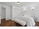 Inviting bedroom with hardwood floors, a plush bed, closet and decorative wall sconces at 290 Dania Dr, Alpharetta, GA 30009