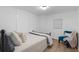 Bright bedroom featuring a bed, chair, and modern decor at 290 Dania Dr, Alpharetta, GA 30009
