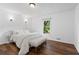 Bright bedroom featuring hardwood floors, a large window, and a comfortable, plush bed at 290 Dania Dr, Alpharetta, GA 30009