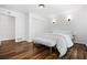 Serene bedroom with a closet, hardwood floors, sconce lights, and white decor at 290 Dania Dr, Alpharetta, GA 30009