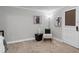 Well-lit bedroom features neutral paint, textured carpet and stylish decor with comfy chair at 290 Dania Dr, Alpharetta, GA 30009