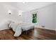 Bright bedroom featuring hardwood floors, sconces, and a window at 290 Dania Dr, Alpharetta, GA 30009