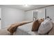 Relaxing bedroom showcases a cozy bed with plush pillows and a warm brown throw blanket at 290 Dania Dr, Alpharetta, GA 30009