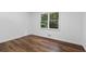 Empty bedroom featuring hardwood floors, a large window, and fresh paint at 290 Dania Dr, Alpharetta, GA 30009