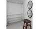 Walk-in closet featuring adjustable shelving and mirrors, plus stool for convenience at 290 Dania Dr, Alpharetta, GA 30009