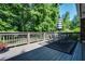 Relaxing deck space with an umbrella, table, chairs, and outdoor rug, surrounded by a lush green yard at 290 Dania Dr, Alpharetta, GA 30009