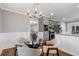 Dining area with modern lighting fixture, adjacent to kitchen, and hardwood floors at 290 Dania Dr, Alpharetta, GA 30009