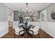 Dining area adjacent to kitchen with modern table, wood floors and view to living room at 290 Dania Dr, Alpharetta, GA 30009