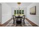 Elegant dining room featuring a modern light fixture, dark accents, and natural light at 290 Dania Dr, Alpharetta, GA 30009