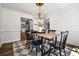 Light-filled dining room showcases stylish lighting and a view into the kitchen at 290 Dania Dr, Alpharetta, GA 30009
