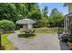 Driveway featuring a patio set, gravel, and greenery at 290 Dania Dr, Alpharetta, GA 30009