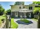 Charming exterior with an umbrella, table, chairs, patio, and lush landscaping, offering a peaceful outdoor space at 290 Dania Dr, Alpharetta, GA 30009