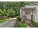 Charming home exterior featuring covered porch, wood siding, and professional landscaping at 290 Dania Dr, Alpharetta, GA 30009