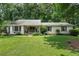 Charming single-story home features a well-manicured lawn and mature trees that provide shade and privacy at 290 Dania Dr, Alpharetta, GA 30009