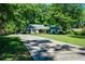 Well-maintained one-story house featuring a lush green lawn and a long, inviting driveway at 290 Dania Dr, Alpharetta, GA 30009