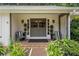 Close-up of the home's entrance with stylish double doors, brick steps, and decorative potted plants at 290 Dania Dr, Alpharetta, GA 30009