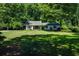 Attractive single-story house boasting a well-kept lawn and a welcoming facade surrounded by trees at 290 Dania Dr, Alpharetta, GA 30009