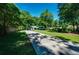 Charming single-story home with an expansive green lawn and mature trees on a sunny day at 290 Dania Dr, Alpharetta, GA 30009