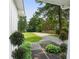 Well-manicured front yard with a long driveway and mature trees create an inviting curb appeal at 290 Dania Dr, Alpharetta, GA 30009