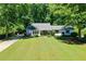 Ranch home with large front yard and mature trees offering plenty of shade at 290 Dania Dr, Alpharetta, GA 30009