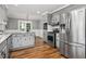 Updated kitchen featuring stainless steel appliances, gray cabinets and tile backsplash at 290 Dania Dr, Alpharetta, GA 30009