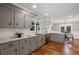 Spacious kitchen featuring gray cabinetry, granite counters, stainless steel appliances, and hardwood floors at 290 Dania Dr, Alpharetta, GA 30009