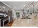 Kitchen view featuring stainless steel appliances, granite countertops, sink, and dining area at 290 Dania Dr, Alpharetta, GA 30009