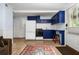 Cozy kitchen with blue cabinets, white appliances, and tile floors at 290 Dania Dr, Alpharetta, GA 30009