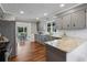 Wide angle view of kitchen showing stainless appliances, granite countertops, and hardwood flooring at 290 Dania Dr, Alpharetta, GA 30009