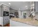 Kitchen island with gray cabinets, granite countertops, stainless steel appliances, and wood floors at 290 Dania Dr, Alpharetta, GA 30009