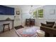 Small eating area with blue cabinets, table, chairs, and large windows at 290 Dania Dr, Alpharetta, GA 30009