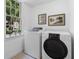 Bright laundry room with large window and modern washer and dryer at 290 Dania Dr, Alpharetta, GA 30009