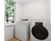 Laundry room with a washer and dryer next to a window at 290 Dania Dr, Alpharetta, GA 30009