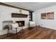 White brick fireplace in a cozy living room with hardwood floors and comfortable seating at 290 Dania Dr, Alpharetta, GA 30009