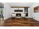 Cozy living room with a whitewashed brick fireplace and sleek hardwood floors at 290 Dania Dr, Alpharetta, GA 30009