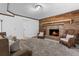 Inviting living room with a brick fireplace and hearth, wood accent wall, and comfortable seating at 290 Dania Dr, Alpharetta, GA 30009