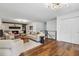 Bright living room with a painted brick fireplace, wood floors, and stylish decor, creating a cozy ambiance at 290 Dania Dr, Alpharetta, GA 30009