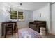 Small living area with dark couch, table, and large windows at 290 Dania Dr, Alpharetta, GA 30009