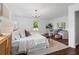 Bright main bedroom features a sitting area, stylish chandelier, and large windows at 290 Dania Dr, Alpharetta, GA 30009