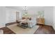 Bright main bedroom features a cozy sitting area, modern chandelier, and wooden floors at 290 Dania Dr, Alpharetta, GA 30009
