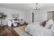 Bright main bedroom features a sitting area, stylish chandelier, and wooden floors at 290 Dania Dr, Alpharetta, GA 30009