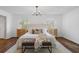 Bright main bedroom features a cozy sitting area, modern chandelier, and wooden floors at 290 Dania Dr, Alpharetta, GA 30009