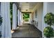 Inviting covered porch featuring brick flooring, white curtains and comfortable seating, creating a relaxing outdoor space at 290 Dania Dr, Alpharetta, GA 30009