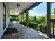 Spacious side porch with brick flooring and views of the green yard at 290 Dania Dr, Alpharetta, GA 30009