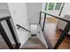 Staircase featuring modern railing that leads downstairs, with hardwood flooring nearby at 290 Dania Dr, Alpharetta, GA 30009