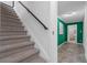 Stairway with carpet runner leads to hallway featuring emerald green accent wall at 290 Dania Dr, Alpharetta, GA 30009