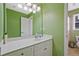 Bright bathroom features a large mirror, vanity, and a shower/tub combination at 6477 Blue Water Dr, Buford, GA 30518