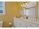 Well-lit bathroom featuring a white vanity, modern fixtures and a neutral color palette at 6477 Blue Water Dr, Buford, GA 30518