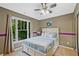 Comfortable bedroom with large window, soft lighting, and cozy decor at 6477 Blue Water Dr, Buford, GA 30518